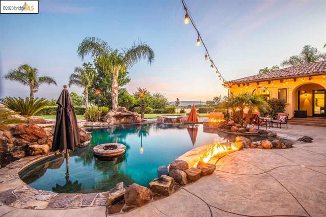 7620 Balfour Rd Brentwood, California Luxury 10 acre property with views of Mt. Diablo and all the amenities of country living yet minutes from Downtown Brentwood. This is more than just a home, it is everything you could ask for in a venue, place to watch a family grow and so much more. The property surroundings include Fruit trees, large backyard grass area, a pool, hot tub, firepit, barn and four car garage. Gourmet kitchen with a wet bar, breakfast nook, island, Viking appliances, and more! Formal dining room and wine cellar. Master bedroom includes office space, gas-burning fireplace, living area and views of the backyard with two entry doors to the outdoor patio. The master bath includes a makeup vanity and his and hers sinks with a jetted tub and walk in shower/sauna. Immaculate living room with high vaulted ceilings, crown molding, fireplace, ceiling fans and hardwood floors with a large entertainment center!