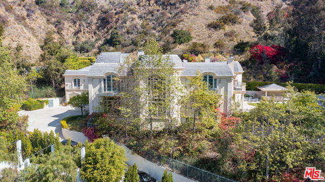 10509 Vestone Way Los Angeles, California First showing is 04/18/21. This grand Contemporary Mediterranean estate is located up a private drive at the end of a secluded cul-de-sac. Enter through gates to an impressive motor court with parking for up to 15 cars and a 5 car garage. The home features large rooms and high ceilings, tall impressive iron and glass entry doors, a two-story entry, marble floors, an elevator, double powder rooms, and a second-floor family area. The 11,251 sq. ft. of interior features 7 bedrooms, 9 baths, a gourmet kitchen with a double island with granite counters, breakfast room with French doors. Spacious family room featuring hardwood floors, wet bar, fireplace, and French doors that lead to a grass lawn and pool with spa and cabana, secondary yard provides room for a sports court and/or children's play area. The formal library includes a loft. Spacious master bedroom with fireplace, separate his and her baths, large walk-in closets, large private balcony with views of the pool.