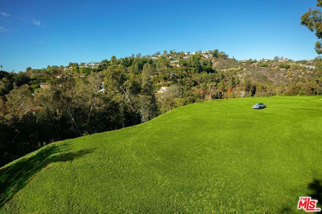 Landmark 4.6-acre estate site in the heart of Bel Air's prime estate section, surrounded by major world class properties valued in excess of $150M. Long private driveway accessed from directly across from famed Hotel Bel Air, leading to elevated, private estate above. Conceptual designs by Architect William Hefner detail an elegant Georgian Inspired compound totaling 25,000 sqft. Program calls for guard house, white brick main house, and multiple guest houses. Rear grounds are centered on axis by a vast lawn space, pool and tennis court. Unique opportunity to build as proposed or create own a legacy residence.