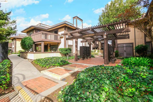 Rear view of house featuring a pergola and a chimney
