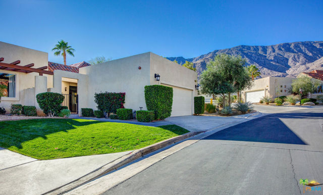 247 S CANYON Circle Palm Springs, California Big, Bold and Beautiful. Extra high, vaulted ceilings greet you entering this jumbo sized 2 bedroom, 2 bath condo creating an impressive volume of space. The large Great Room is loaded with opportunities for intimate areas by the cozy fireplace, sunny breakfast nook and generous dining area. The kitchen is a cook's delight with wonderful counter space, newer appliances and ample storage. The large main suite has access to a private outdoor area plus a show-stopping dual sided fireplace visible from the bedroom area and the deep soaking tub (it's divine!) in the recently renovated spa style bath. A massive walk-in closet completes the primary suite. There is a nice separation of space from the large 2nd bedroom and even more storage. The renovated 2nd bath is roomy and spacious with access from 2nd bedroom and public space. Outdoor space abounds with open air and covered areas in the large private garden more akin to a single family than a condo. There is a two car garage with ample storage. Canyon Heights is located in coveted South Palm Springs on land you own surrounded by Oswit Canyon yet minutes to all conveniences. The community has an impressive amenity list with club house, tennis courts, pickleball courts along with multiple pools and spa areas. This one is sure to please!