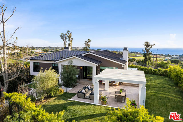 Located in the desirable Malibu Park neighborhood, this newly finished contemporary masterpiece is situated to capture ocean views and plenty of natural light. The home features an open floor plan with oversized windows, wide-plank hardwood floors, state-of-the-art appliances, high ceilings, and a surround-sound speaker system. A gated driveway leads to the two car garage that sits just below the beautiful lounge and garden area, which frames the modern front pivot door. The main level features a sun drenched open kitchen with marble countertops, a dining area with built-in bench seating, the living room, and all three bedrooms. The primary suite boasts ocean views, a fireplace, a walk-in closet, and a spa-style bathroom with his and her vanities. Down from the main floor is the garage, large laundry room, additional storage, and office area with built-in desk. The grounds are lush and calming and feature a pergola with plenty of seating, an ocean view patio, luxurious spa, putting green, and room for an outdoor kitchen. This home epitomizes the Malibu life with its seamless indoor-outdoor flow, impeccable finishes, and scenic views.