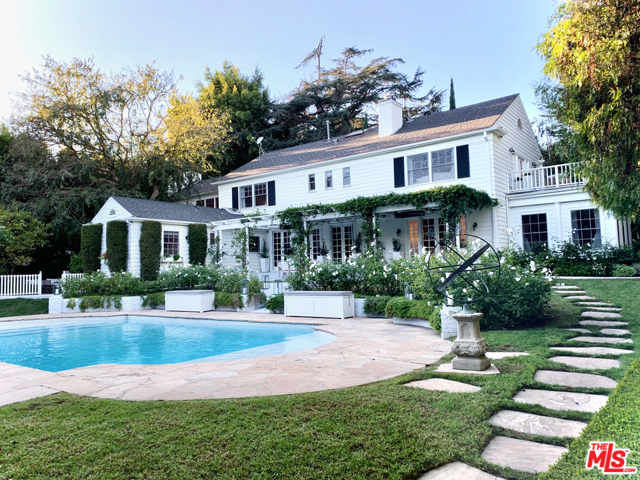 101 Loring Avenue Los Angeles, California Stately Paul Williams on one of the largest lots in Little Holmby. Mature hedging and trees offer absolute privacy. Formal entry welcomes you to the elegantly scaled public spaces, perfect for entertaining. Beautiful millwork, high end finishes and French doors throughout all overlook the bucolic grounds. Formal living room with fireplace and attached sunroom anchor one side of the home, while the gracious dining room with wainscoting, eat-in gourmet kitchen and family room anchor the other. Upstairs features 4 bedrooms including a luxurious principal suite with sumptuous bathroom with soaking tub, two walk-in closets and private balcony. Additional maids and laundry room complete the main house. Separate two-story guest house with high-end screening room, spacious home office or living area, kitchenette and bathroom. Grounds feature large pool with Baja shelf, multiple sitting areas with fireplace and lush gardens. Gated driveway with 2-car garage and large motor court.