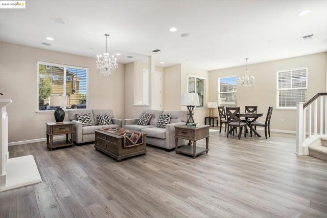 Living room with a chandelier, recessed lighting, and light wood finished floors