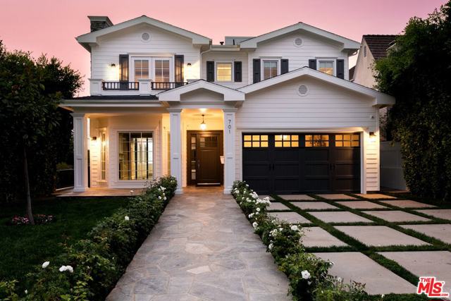 701 VIA DE LA PAZ Pacific Palisades, California Quintessential California Cape Cod newly remodeled in 2020. This elegant and modern coastal traditional is nestled between the Majestic Via Bluffs and Caruso's Village. Enter through a rose garden path into the formal living room with fireplace, formal dining room, powder room, and separate guest quarters. The open floor plan connects the family room to a terrace overlooking a serene backyard. Entertain in the gourmet chefs kitchen with Viking appliances and an oversized Calacatta center island, or enjoy breakfast in the adjoining sun-filled breakfast nook. Atop the custom staircase is the Primary suite with fireplace, private balcony with ocean and sunset views, steam shower, walk in closet, and 3 more en-suite bedrooms. Entertainers rooftop deck showcases 360 degree views of the ocean, surrounding hills, and the Santa Monica mountains. There is a lower level with a family room, fireplace, custom built-in home theater, a 3-D Movie Projector, bonus area, gym, and office. Room for pool