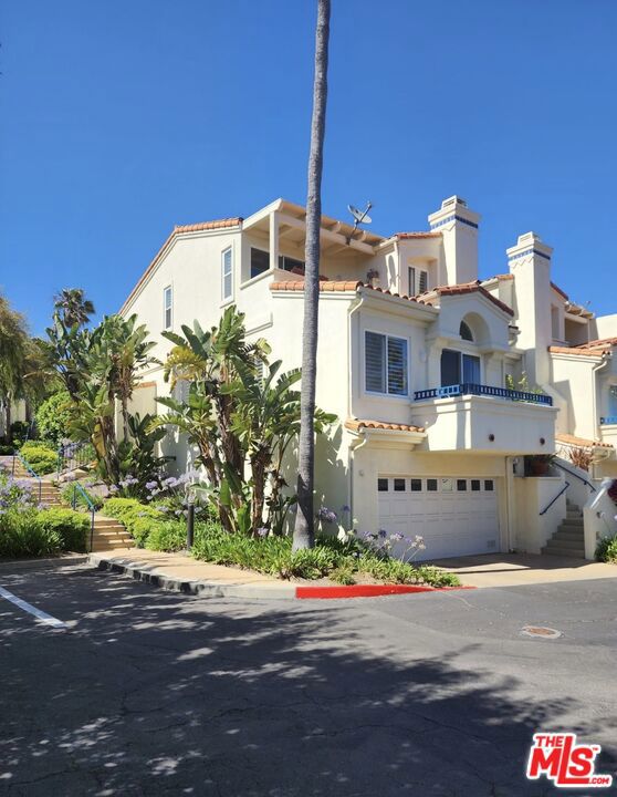 Welcome to this exceptional 3-level condo at The Pointe at Malibu, perfectly situated at the very end of the complex and facing west, offering breathtaking sunset views and peek-a-boo ocean views. As an end unit, this residence enjoys an unparalleled level of privacy, complemented by an abundance of natural light that filters in from multiple directions, creating a bright and airy ambiance throughout. The moment you step inside, you'll be captivated by the grandeur of high ceilings and the timeless elegance of hardwood flooring.  Plantation shutters adorn all windows, allowing you to control the flow of light and maintain your desired level of privacy effortlessly. In addition to the 3 balconies, the main floor boasts a private patio, accessible from the kitchen and guest bedroom, where you can indulge in outdoor culinary delights with a built-in BBQ and relax to the soothing sounds of a charming fountain.  Wine enthusiasts will rejoice at the sight of the impressive 3,000-bottle temperature-controlled wine cellar.  This private, bright, end unit condo is a rare gem waiting to be cherished by its new owners.  Enjoy close access to Paradise Cove, Zuma Beach, Pepperdine, Point Dume shopping, and Malibu schools. The Pointe at Malibu is gated and has great amenities including pool, spa, gym and pickle ball and tennis courts. Welcome home to your slice paradise, your Malibu life awaits!