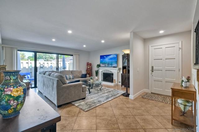 Living room has lots of natural light due to the large sliding glass doors leading to the patio area.