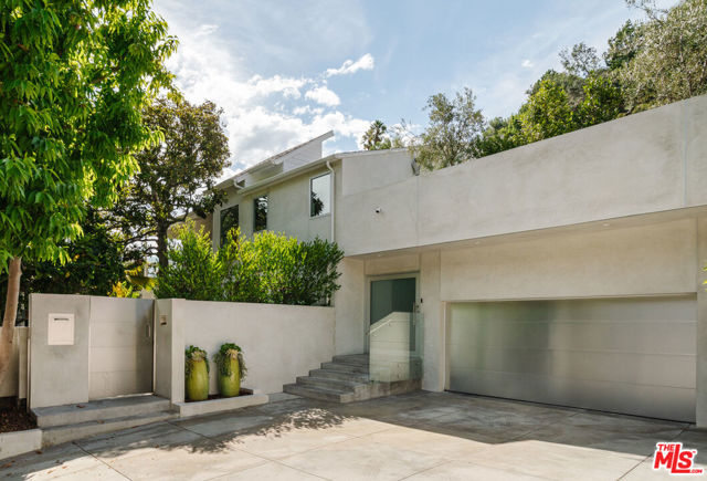 1325 N Wetherly Drive Los Angeles, California Extraordinary, newly upgraded home with designer high-end finishes, set in the premier section above the Sunset Strip, a stone's throw away from Soho House, world-class shops, and new restaurants. This private modern oasis is perfection! Enter through your gated driveway into a world all its own. The private courtyard effortlessly flows into the main floor which features a custom chefs kitchen fully adorned with Miele appliances, dining room, living room, office, upgraded theater, laundry, garage and an en-suite bedroom, all with oversized windows flooding light in from every corner. Just when you think you've seen it all, the soundproofed home cinema equipped with Bowers and Wilkins speakers and a state-of-the-art 4k projector all seamlessly controlled via Control4 is not to be missed. Upstairs, you will find three en-suite bedrooms, all perfectly their own. The primary bedroom is a sanctuary with its own sitting area and two attached quiet patios. Outside, you have a private, flat yard featuring a large swimming pool and multiple outdoor areas all wired for Sonos, including an outdoor rooftop deck that completes this incredible home. The perfect way to enjoy the indoor-outdoor Southern California lifestyle!