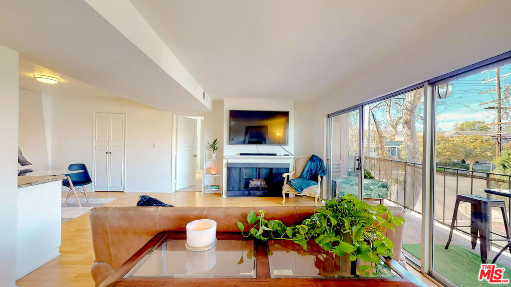 This 2BR/2BA corner unit in Sherman Oaks features a long balcony from which to enjoy al fresco dining or to sit back and soak up SoCal's sunny weather. Inside the condo is a large open concept floor plan which is anchored by a living room with a fireplace. The residence's kitchen features granite countertops, plenty of storage, and allows for entertaining to flow into dining and living areas. The dining area includes a wet bar. Bedrooms are conveniently located on either side of the unit, providing ultimate privacy. The primary bedroom is flooded with natural light, has ample closet space, and an en-suite bathroom that includes dual vanities and a soaking tub. The condo's guest suite also has its own bathroom and gets plenty of light. BONUS ALERT: There is brand-new carpet in both bedrooms and a full-size washer and dryer inside the unit. Building amenities include a heated swimming pool, barbecue area, underground gated access garage (with 2 parking spots), and direct access elevator. Close to all the area has to offer. Easy access to major studios.