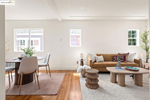 Living room with beamed ceiling and hardwood / wood-style flooring