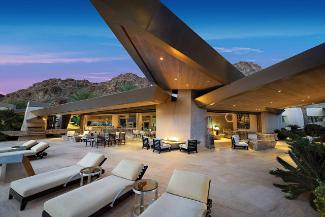 Exquisite is an understatement; with every detail of this property far exceeding expectations. The private hillside location coupled with the imagination of renown designer Guy Dreier resulted in a masterpiece. The private driveway takes you through a canyon of natural beauty to a home that fits right into the terrain. Entering the electronic glass door the floor to ceiling glass, pocket sliders, and picture windows are the back drop for living in this beautifully designed estate. Its sophistication and quality is quiet living at its finest. Open space and intimate areas with a custom designed fireplace as the centerpiece for the living and dining; with a touch of a button the indoor space extends seamlessly to the outdoor extended living with water falls and additional fireplaces and numerous entertaining areas. The state of the art kitchen with hydrolic lift in a granite island for hidden appliances. A master suite one can only dream about with glass windows bringing the serenity of nature into this tranquil space including a private pool to step right into, indoor and outdoor fireplace, and spa-like bathroom with onyx detail, his/her amenities including indoor and outdoor showers. Both his and her offices, a gym with a cedar sauna. 3 well-appointed guest suites including a detached casita with its own indoor and outdoor fireplace and patio. An entertaining pool provides enjoyment and enhances the outdoor living.
