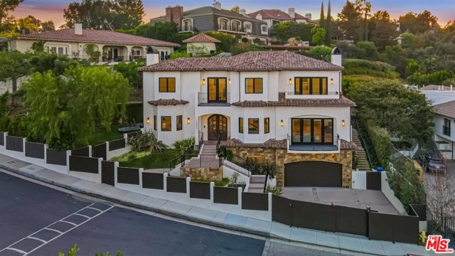 12043 Summit Circle Beverly Hills, California This 5 bed/7 bath Contemporary-Spanish home located in the guard-gated Summit Estates. With scenic city views spanning the entire valley, this trophy property is a rare find. The 3 story home sits on a quarter acre of land and boasts an open floor plan, accented by warm brushed oak flooring and contemporary finishes. The yard is designed for entertaining with a built in Wolf BBQ/refrigerator, Baja style pool, and large grassy area. The expansive master bedroom and bath with amazing city views awaits you. The large open kitchen has Fleetwood doors that lead to the veranda, maximizing the California lifestyle. Making your way from the main level to the lower level you will be welcomed by ultimate lounge & entertainment space. It consists of a full bar and wine cellar, a gym/ and or additional office space, and a full laundry room. Some amenities include: Control 4 smart home system (home lighting and sound), Nest smart temperature control, wine cellar, custom cabinetry, custom plaster fireplaces, yoga room, Bianco Bella polished marble countertops, grass cloth wallpaper, penny round marble mosaic flooring, and solid brass hardware. This architectural masterpiece must be experienced firsthand.