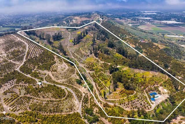 Over 54 acres of rich ag land nestled in the hills of Camarillo with endless views of the coastline and Channel Islands!  This beautiful parcel has tremendous potential all within 10 minutes of the City of Camarillo and approximately an hour of Los Angeles and Santa Barbarba.  As you enter the gates, you will find acres of Haas avocado trees and passion fruit vines fed by 2 private working wells and supplemented by public water supplied by Camrosa Water.  Build your custom dream home while enjoying the tennis court, workshop/garage and casita.  Great potential for equestrain facilities as well.  Come enjoy the peaceful tranquility of Shangri-La Grove and let your imagination soar!