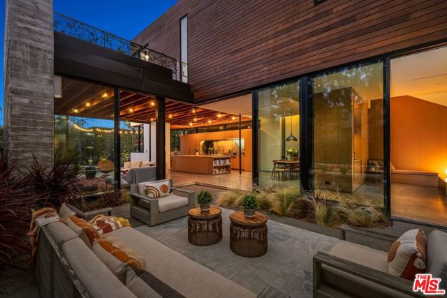 824 22nd Street Santa Monica, California Stunning architectural masterpiece designed by the acclaimed Dub Studios. This extraordinary two-story home was built to the 9's in 2016 with high ceilings and only the finest quality finishes. The main level has floor-to-ceiling Fleetwood sliding glass doors (with motorized shades) that retract to create a modern oasis of indoor/ outdoor living. Chef's kitchen is open to the living and outdoor areas and boasts top-of-the-line appliances including, Liebherr Refrigerator/Freezer, WOLF dual built-in oven, and 6-burner WOLF range with Futuro hidden skylight range hood. A cozy breakfast nook in the kitchen looks out to an expansive, grassy backyard. The kitchen has stylish exposed ceilings that extend above the living area which has beautiful built-in cabinetry. The main floor also includes a lounge area with a built-in bar and a hidden closet that houses a Summit wine fridge. There is one bedroom/office and bath with mosaic tiled shower downstairs. The second floor has sumptuous walnut flooring and a large open lounge/seating area that separates the primary suite from the two secondary bedrooms. The primary bedroom has a walk-in closet and a private Ipe deck with planters filled with fragrant jasmine. The primary bathroom has a soaking spa tub, an I-Steam steam shower, a walnut free-standing vanity with double sinks, Vola faucets, and Geberit enclosed toilet. Good-sized secondary bedrooms have ample storage space and a second upstairs bath with gorgeous subway tiling, a Duravit tub, Dorn Bracht fixtures, Kohler sink and Kohler Japanese-style toilet. Both bathroom floors upstairs are wired for heating. The laundry is conveniently located on the upper level near the bedrooms. The spacious, west-facing, grassy backyard is perfect for BBQing, entertaining, and relaxing under the summer stars. This home is perfectly balanced with sleek and sophisticated details and the warmth of wood throughout. Outstanding location less than a block to Montana Ave and in the coveted Franklin School district.