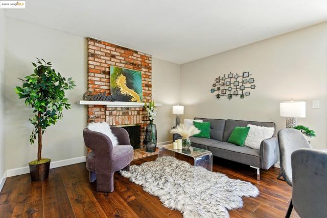 Living area featuring hardwood / wood-style floors and a brick fireplace