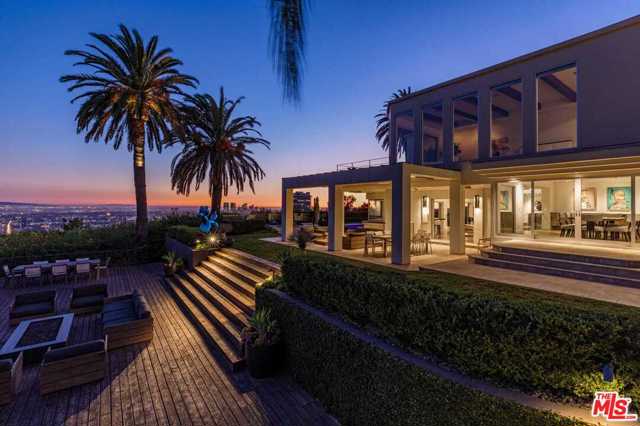 1380 Mockingbird Place Los Angeles, California Perched high above the city on one of the largest promontories in the Bird Streets, this rare offering provides 2 unique residential opportunities. Enjoy this 14,000-sq.ft. modern villa on prime acreage with panoramic views from LA to the Pacific Ocean boasting 6 ensuite bedrooms, incl. a 2,500-sq.ft. primary suite, 11 baths, chef's kitchen, 2-story living room, theater, game room, gym, wine cellar, pool/spa, motor court w/20+ car parking, 4-car garage & superior privacy. Just minutes from Beverly Hills, remain connected to the heartbeat of LA, but with virtually no road noise in a contemporary oasis. Alternatively, purchase includes approved permits & plans created by acclaimed architectural firm SAOTA, spanning 30,000 sq.ft. of living space, with size, land value, & views in a class of their own. The main home & guesthouse feature 8 bed, 9 bath, theater, bowling alley, danceclub, subterranean garage, floor-to-ceiling glass walls, Padel court w/ample space for indoor & outdoor dining.
