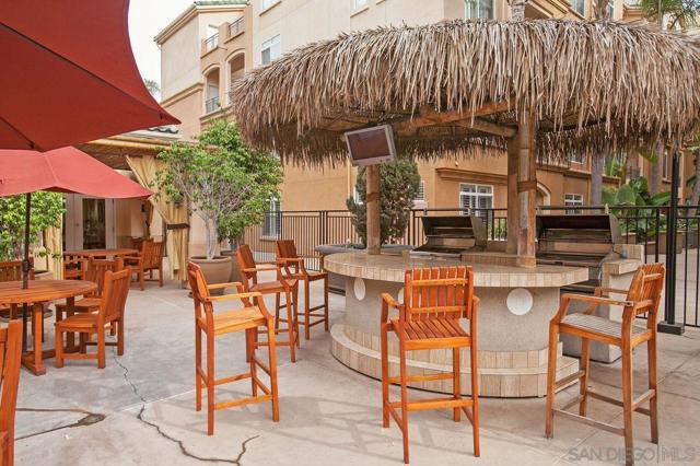 Cabana by the pool with BBQ, shower, and spa