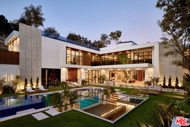 13187 Chalon Road Los Angeles, California Experience a carefree, high-end resort-style living at Allure, meticulously designed and built by the renowned Designer and Developer, Ramtin Ray Nosrati. Nestled in a picturesque piece of paradise, this property is surrounded by the natural beauty of California flora and offers breathtaking canyon and peek a boo city views. Spread over 1.3 acres of mostly flat, usable land, it provides an extraordinary package of amenities that hasn't been seen in recent memory.This residence is a dream come true for both those seeking relaxation and sports enthusiasts. It boasts a dedicated pickleball court, a professional-sized basketball/sports court inspired by Michael Jordan, and a putting green, all set within a flourishing, leafy oasis. The grand gated motor court can accommodate up to ten cars, and as guests arrive, they are welcomed by vibrant moss walls merging with the pristine beauty of the surrounding hills.Inside, the gourmet chef's kitchen is adorned with stunning bookmatched stone slabs, a triple waterfall island, and top-of-the-line Miele appliances, including a commercial-grade walk-in refrigerator in the caterer's galley. The bar and wine room are exceptional showpieces designed to create picture-perfect moments for visiting guests. The theater is expertly designed to deliver an authentic cinematic experience, evoking a sense of nostalgia for the silver screen.Upstairs, the primary wing that rivals any 5-star hotel suite encompasses a generous 3,000 square feet and features a lounge, a two-sided fireplace, an exquisite use of linear wood design, and a luxurious spa-like bathroom adorned with imported European stone. It also includes dual closet changing rooms, one of which has a walk-out balcony with a fire pit, providing a view of the grounds below. Tropical palms grace the hillside landscape, visible through oversized picture windows from nearly every room.Additional amenities include an office, gym, sauna, and mudroom. Live a laid-back life as if you're perpetually on vacation in your very own ultra-private, family-friendly luxury resort. This property offers a cabana with an outdoor kitchen and a rainfall curtain, a relaxation loggia, a 16-person sunken fire pit with a glass view of the pool, multiple sitting areas, organic gardens, and a 3,000-square-foot rooftop deck designed for entertaining beneath the California city lights sky.Ideally tucked away in a secluded park-like setting with virtually no neighbors and just minutes from Sunset, Allure promises a joyful existence and uninterrupted leisure in one of the world's most sought-after locations. Come and discover the epitome of contemporary luxury and live in one of the most private homes in Mandeville Canyon.