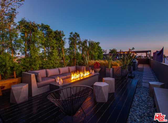 406 Grand Boulevard Venice, California Find your oasis in this newly remodeled 4 bed, 5 bath masterpiece located in the heart of Venice Beach. Steps away from surf, sun, shopping, restaurants, and the iconic Venice sign; it's the best of LA coastal living right at your fingertips! The stunning open floor plan showcases a ground level living area and gourmet kitchen equipped with Miele appliances, Cesarstone countertops, and large sliding doors flowing seamlessly into front and side patios; a second level with large jr. primary bedroom, guest room, gym/study and laundry; and fabulous third level primary bedroom with spacious en-suite bath, walk-in closet and projection home theatre. Three light and bright levels of living are topped with a freshly renovated roof deck, featuring a private spa, fire pit, kitchen/BBQ, covered dining, lush landscaping and multiple decks to take in the panoramic views. Ocean breezes and natural light fill the newly converted garage, making for an inspiring home office, studio or remote learning space. Side-by-side parking for 2 large cars under attached carport, complete with gated security.