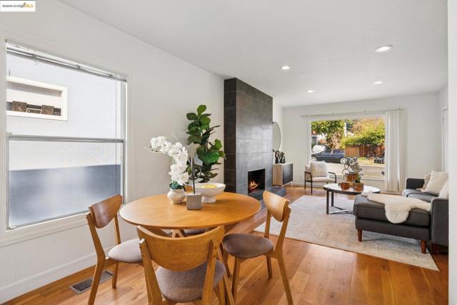 Dining room featuring a tile fireplace, wood finished floors, and recessed lighting