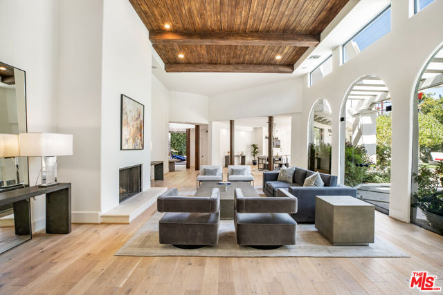 1571 Tower Grove Drive Beverly Hills, California Spacious and stunning, this massive Mediterranean Revival villa is truly a must see! The gated entrance offers both security and privacy while the home itself boasts an impressive 6 bedrooms and 7 full bathrooms (+2 Half Baths) over a sprawling *7500 sq ft of living space!Featuring soaring ceiling heights throughout, the floorplan flows effortlessly to evoke feelings of comfort and serenity. Floor-to-ceiling windows in the living room overlook secluded grounds with views of the beautiful swimmer's pool, veranda, and impeccably landscaped gardens. The open flow, remodeled kitchen comes with top- of- the- line, stainless steel appliances. Entertain or relax in the oversized library with fireplace and bar.Downstairs features 2 oversized bedrooms and maids rooms. Upstairs there is a master suite with dual bath & walk-in closets. As well as two additional ensuite bedrooms with walk-in closets.Step out onto the deck and experience the magic of the views to downtown LA/Ocean and the city ligh