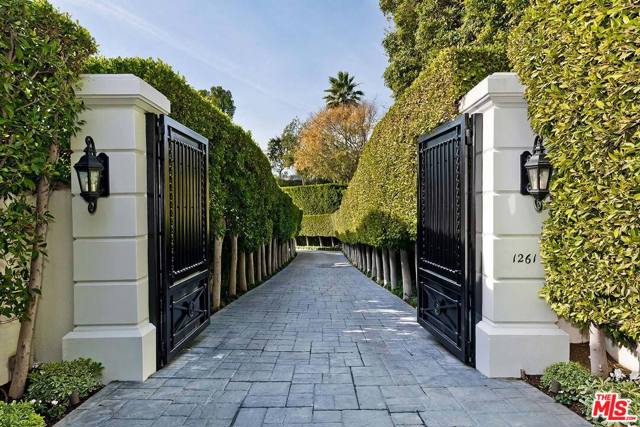 1261 Tower Grove Drive Beverly Hills, California First Viewings by appointment only on Tuesday, February 16th between 11-2. Please RSVP by email ONLY along with your signed PEAD for access. In the most coveted section of lower BHPO sits this remarkably secluded and timelessly elegant Contemporary Villa view estate set on over 40,000 square feet of land. Approached via a gated and hedged "billionaires' row" private drive coupled with an enormous motorcourt, this rare gem will please the entertainer in all. Panoramic views of the city and ocean are exhibited from many sunlit rooms along with super high ceilings, wide-plank wood floors, and walls of glass. The living room, study/library, master retreat, and dining room all open to the grounds with patios, stunning elongated lap pool, spa, and views. Grand main floor master retreat with sitting area, fireplace, views, dual crisp white baths, and room-size walk-ins. 3 generous guest bedroom suites are located in two separate upstairs wings. Chef's center-isle kitchen with top newer stainless appliances and big atrium-style breakfast area. Featuring a pedigree from world-renowned designer, Kalef Alaton, this estate will be certain to enchant and impress its fortunate new owner.