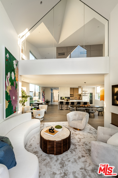 8600 Wilshire Boulevard PH 18 Beverly Hills, California Perched at the top 8600 Wilshire, this Penthouse features soaring ceiling heights, floor-to-ceiling windows, and a signature sculptural staircase connecting the lower and upper floors. This two-story, three-bedroom penthouse boasts abundant natural light, exquisite gathering spaces and expansive views across the city. PH18 is a beautifully appointed residence with spacious interior living spaces that open to generous outdoor living area and private terrace. The exterior, clad in a stunning architectural facade of aluminum composite panels, reinterpret the classical proportions of each Penthouse in a contemporary aesthetic. PH18 features a private foyer with direct lift access from the lobby and the subterranean parking garage.