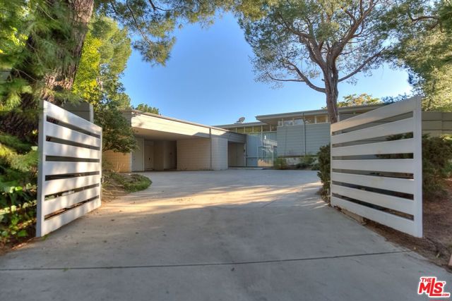 1700 CARLA RIDGE Beverly Hills, California A Mid Century lover's dream in Beverly Hills!!! Three level REX LOTERY trophy home in Trousdale. Gated, on a good sized lot with pool,yard and beautiful city views. Floor to ceiling windows make this a very bright home. Large primary suite has huge closet space, sits alone in the upper level. Powder room and family room. Maids room and bath. Two additional bedroom suites downstairs open to yard. Big entry room walks you into an ample living room with fireplace, opening up to large yard with pool and views. Formal dining room, and spacious kitchen. Three car covered parking and lots of additional parking behind gates. Almost four thousand square feet per tax assessor.