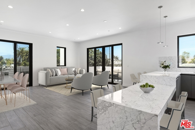 1444 11Th Street 8 Santa Monica, California Rare new construction condominium in prime Santa Monica! Be the first to live in this top floor unit with spacious open floor plan, high ceilings, and no shared walls. Natural sunlight floods the entertaining space with large sliding glass doors and corner windows that showcase tree top views. Relax on the adjoining private balcony terrace and cook in the chefs kitchen with modern grey cabinetry, expansive Carrera marble waterfall countertops, and brand new appliances. Master suite has its own private terrace, stunning bathroom with double sinks, and walk-in closet. Guest bedroom is equally inviting with walk-in closet and beautiful en suite bathroom. Wood-like porcelain floors throughout provide easy living. In unit washer/dryer, LED recessed lighting, two side-by-side subterranean parking spaces, and large communal rooftop deck with mountain and city views. Enjoy the Santa Monica lifestyle at its best.