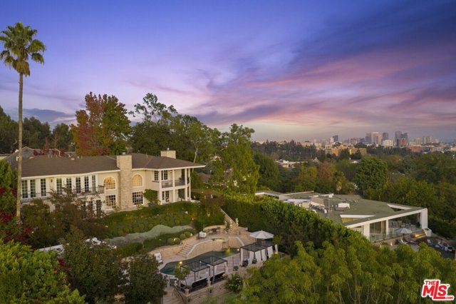 161 Ashdale Place Los Angeles, California Prestigious Bel Air gated Estate sprawling on over 1/2 acre this modern traditional features 7bd/7ba with enchanting unobstructed city to ocean views nestled on quiet cul-de-sac. Striking grand entry bathed in natural light is revealed by well thought out floor plan leaving endless entertainment for your family. Main level features grand living room with soaring ceilings, gentlemans bar with double walk-in wine cellars, formal/informal dining, maids quarters, private office, and polished chefs kitchen complemented by breakfast bar, butlers pantry and family room leading to dining al fresco overlooking the Getty. Second level features 4 generously sized ensuite bedrooms and theatre doubles as 5th bedroom. Vast and expansive grounds surrounded by manicured tiered foliage allows beauty at every turn. Relaxation gifted poolside and complemented with pool/guest retreat house, calming water features and multiple outdoor kitchen areas. All lead way to redefined grass gardens and courtyard.