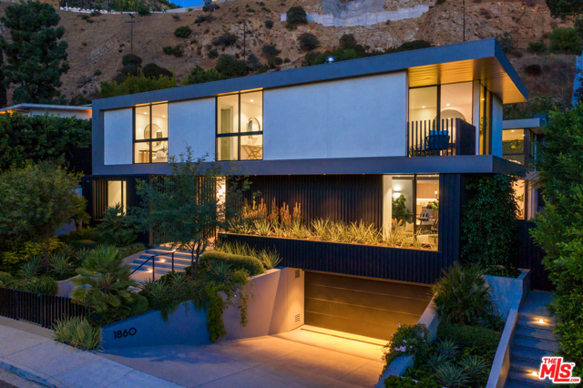 1860 N Doheny Drive Los Angeles, California Rare opportunity to own a newly constructed and never resided in contemporary estate in the famed Bird Streets of the Hollywood Hills. Set in the highest point of the Doheny Estates, the home has 5 beds/8 baths across a total of 8,200 SF complete with skyline views across LA. The main floor showcases a custom zero edge pool and exterior living areas with dramatic walls of glass sliding doors, blurring the lines of indoors and outdoors. The formal living and dining rooms, complete with a bespoke bar and glass wine vault, are ideal for entertaining while the kitchen opens into an airy family room. Upstairs, a gracious primary suite with a massage room, dual walk in closets and private outdoor space takes advantage of the homes views while 4 more ensuite bedrooms and a second living room round out the floor. Added features and details such as a media room, fitness room, surround sound system, built-in smart home technology, and intricate designer touches elevate the property to the highest luxury standard. Incredible value for this prominent Doheny Estates home that offers seclusion paired with ease of access to the Sunset Strip, West Hollywood, and Beverly Hills.