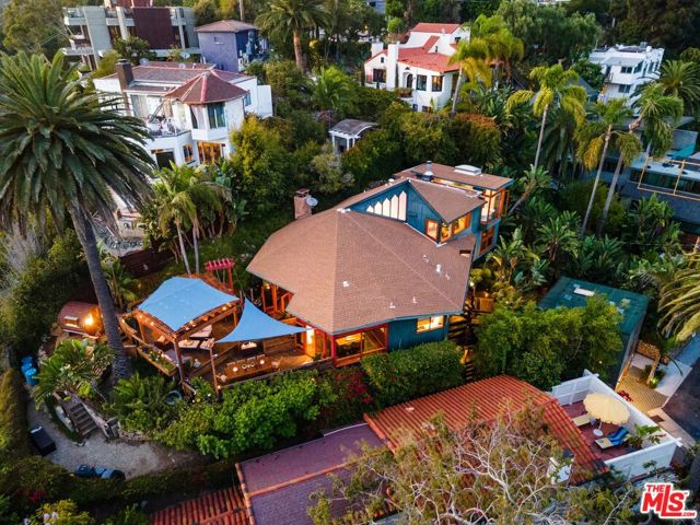 323 Sumac Lane Santa Monica, California This distinctive wood and glass architectural is located in Bohemian Chic Santa Monica Canyon. Perched on a lushly landscaped promontory between Pacific Palisades and Santa Monica and adjacent to the neighborhood's discrete series of stairs leading to the Canyon's beach and restaurants below. As you enter the compound, you feel the island style Bali treehouse vibe. The main house features high wood-beamed ceilings with a radiating design anchoring this property's Zen feeling throughout. There are three bedrooms including the second story master suite with spa-like master bathroom and walk-in closets providing a romantic and restful retreat amongst the treetops. The kitchen and breakfast area enjoy easy access to the open-air decks providing abundant outdoor living and whitewater ocean views across the verdant canyon. A surprise guest suite nestled amongst the tropical landscaping welcomes visitors via its own private entrance. Completing this living sanctuary, the detached studio with loft and bath provides an inspirational environment for work or play. Together with all the world class amenities on the Westside, you'll enjoy life above the fray in this luscious tropical hideaway.