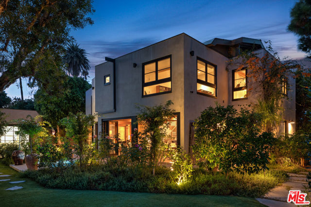 Nestled within the vibrant and eclectic neighborhood of Venice Beach, discover a unique gem that stands as one of the most captivating and expansive properties in the Silver Triangle. As you step onto the property, you are welcomed into a sprawling double-lot retreat, a secret garden that has been artfully co-designed by world-renowned rosarians, Stephen Scanniello and Tom Carruth. Scaniello celebrated for his work transforming the Cranford Rose Garden and Carruth, The Huntington Library, Art Museum, and Botanical Gardens in Pasadena. Both rosarians have collaborated to curate a botanical paradise of unparalleled beauty. Hidden behind newly constructed stucco, steel, and Ipe privacy walls, flanked by majestic mature pine trees and a soaring Bay Laurel hedge, you'll find over 25 rare and heritage rose varieties, including the breathtaking Perfume Breeze with four columns thoughtfully positioned around a fully renovated hot tub. The garden also boasts graceful Malelucas, providing a private oasis within this corner lot, along with a grand Eucalyptus tree that shades the outdoor kitchen. Privacy is further enhanced by a statuesque Ficus in the rear garden, and numerous mature citrus trees bearing lemons, limes, and tangelos. The interior of this home is equally captivating, with an open and airy floor plan featuring soaring ceilings and skylights. The accordion glass doors spanning the entire length of the house seamlessly connect the indoors to the outdoor patio. The large chef's kitchen is a dream for entertainers, showcasing brand-new, high-end appliances and custom tile work meticulously crafted adds a unique touch. Upstairs, the transformation continues with an all-new floor plan that offers three en-suite bedrooms, each with its own bathtub. Solid white oak floors grace the entire level, complemented by a new staircase. The primary suite is a sanctuary, featuring a redesigned bathroom with custom solid oak vanities, natural stone with a waterfall edge, and fixtures by Watermark Designs. The spacious custom-built white oak closet provides ample storage, and the spa-like bathroom includes a his-and-her shower and a soaking tub. An adjoining meditation loft offers a tranquil escape. The second primary suite offers a stunning bathroom with a double vanity, a freestanding soaking tub, and a natural stone shower. The third bedroom suite features a bathroom adorned with natural stone and handmade ceramic tiles, and a custom white oak vanity and closet. Antique Italian hardware and built-in dresser space complete the closet, and a hall closet with built-in shelving adds to the storage solutions. The property has been upgraded with a new roof and all-new solid, old-growth mahogany windows and doors, which have been imported from Germany. For outdoor enthusiasts, an outdoor kitchen with a Viking grill and a large sink provides a delightful space for al fresco dining. An outdoor bath with a shower easily connects to the existing garage, which is primed for an ADU (Accessory Dwelling Unit) conversion, presenting an excellent opportunity for additional living space. The spacious three-car garage is a versatile area, offering a full bath. a washer-dryer, and two additional refrigerators making it a flexible space that can serve as a studio, office, or guest unit. This magical Venice Beach property harmoniously blends the artistry of a secret garden with the allure of a meticulously designed interior, creating a truly magical and extraordinary living experience.