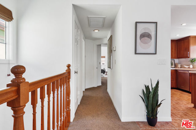 Hallway to powder room & primary suite