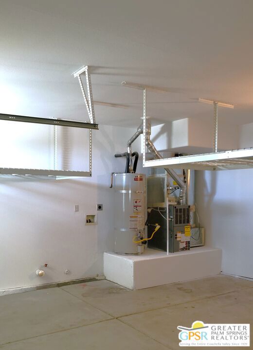 Metal Overhead Storage Near The Oversized Hot Water Heater - HV/AC Has Been Professionally Maintained