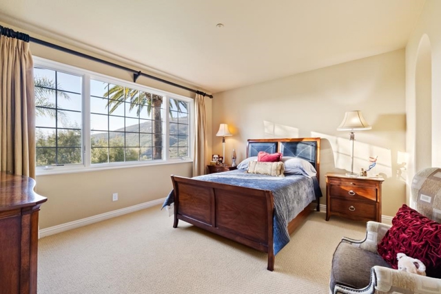 Upstairs guest bedroom with stunning views of mountains, backyard and golf course