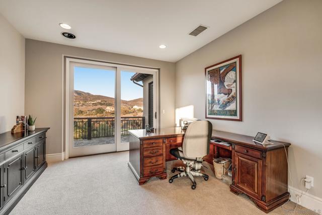 Upstairs loft/office with breathtaking views, natural light, and direct access to a private balcony. A versatile space perfect for working from home or relaxing.