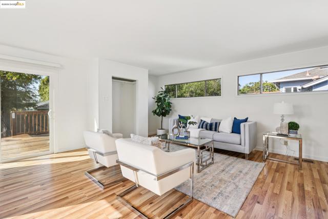 Living room with light wood-style floors and baseboards
