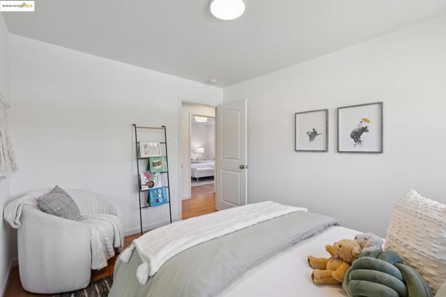 Bedroom featuring wood finished floors and baseboards