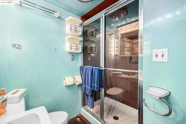 Bathroom with toilet and a stall shower