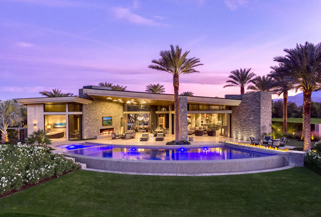 This stunning architectural masterpiece located at The Madison Club was designed by renowned architect Kristi Hanson. This one-of-a-kind home sits on nearly one acre and features dramatic fire and water features throughout. Floor to ceiling glass doors open the home to the panoramic mountain views and the 3rd fairway of the Tom Fazio designed golf course, just beyond the sparkling infinity pool. This is a true entertainers dream home outfitted with a state-of-the-art theatre equipped with the highest quality sound standards and acoustics, 3D technology and an extensive premium film library. Perfect your short game on your private putting green. The gorgeous original artwork throughout the property is a delight for the eyes. Relax in the spacious master retreat with dramatic fireplace and pocket glass doors. This home is a true work of art and equipped with solar panels for added value.