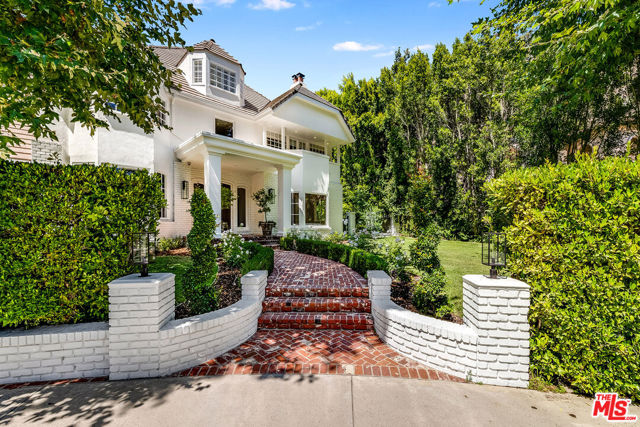 1498 Moraga Drive Los Angeles, California Located in Bel Air in the exclusive 24hour guard gated Moraga Estates, tucked into the canyon and the last house at the end of a cul-de-sac, this completely remodeled stunning transitionally designed Estate with over 10,000 square feet. of living space offers complete privacy, luxury, and an oasis for entertaining. Grand entrance with gorgeous staircase and all new custom wide wood plank floors throughout the house. The property has all new systems: including all electrical, recessed LED lighting HVAC, AV, security/camera, central vac, pool, spa and hydro water filtration system. The foyer leads to a large formal dining room with custom built-ins, and a silverleaf soffit ceiling. Step down into the light flooded formal living room with fireplace that flows into the oversized entertainers dream family room, all with wood burning fireplace, fabulous bar and a unique Moroccan inspired seating rotunda. French doors throughout family room and kitchen all open to the spectacular backyard with the stunning backdrop of the Santa Monica mountains. The white custom cabinets and chef's kitchen with stunning marble counters, backsplash, eat in island, oversized Sub Zero, Wolf 6 burner, double oven with griddle/grill plus a steam oven, refrigerated beverage drawers and built-in coffee /cappuccino machine with a fabulous butler's pantry with storage drawers and shelves to tuck away appliances. The large breakfast area is sundrenched from the French doors on all sides. Additionally, on the first floor are the maid's quarters, laundry room with double washers/dryers, powder/pool bath and 3-car garage. The second story with the tremendous primary bedroom suite & sitting area, fireplace, balcony, custom walk-in closets, and spectacular bath with steam shower and jacuzzi tub, surrounded by windows, leads to a third story giant gym with skylights and mirrored walls that is a massive space for exercise equipment and even an office or playroom. There are several huge storage closets as well. There are three great en suite children's bedrooms and a guest bedroom and bath. The incredible wood beamed media/game room is expansive with wet bar and has a separate entrance into the backyard, which allows for continuous flow to the property. Originally Magic Johnson's home, it was designed for total privacy and entertaining. You can watch your guests and family play basketball through the glass windows from the media room into the indoor hoop court, designed especially for Magic. It is fully equipped with locker room and signed walls by many notable NBA players. The grounds are truly a special private haven that offer a serene and picturesque setting with lush canyon views, tall surrounding hedges for total privacy, large grass area, brick patios, built-in BBQ, fire pit ,vegetable garden, pool with built in seating and spa. This is truly a unique and magnificent estate, perfect for those seeking the ultimate at-home retreat and great space for entertaining in a private, secure community. House square footage breakdown is as follows: 1st Level 4,436, 2nd Level 4,188, 3rd Level 1,050, Garage 992 = 10,666 sq.ft.