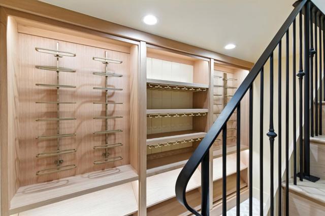 Downstairs wine room with built-in racks.