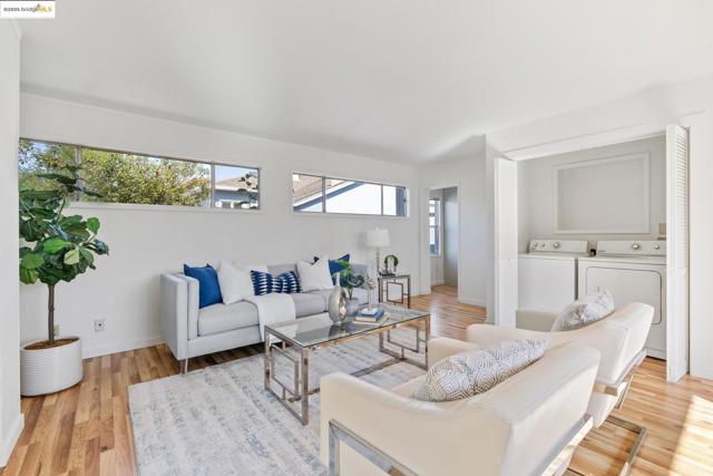 Living area featuring washing machine and dryer and light wood-type flooring