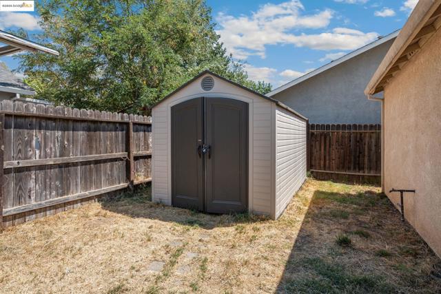 View of shed with a fenced backyard