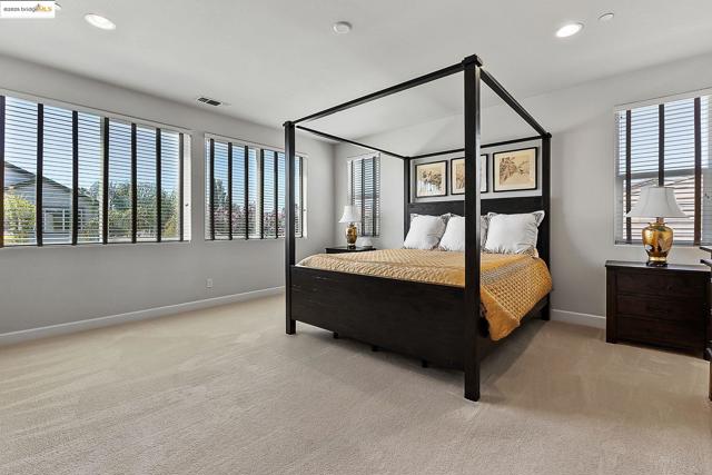 Bedroom with recessed lighting and light carpet