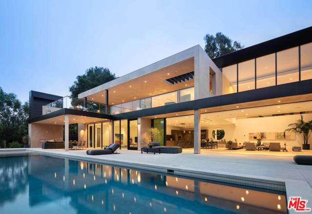 2600 Hutton Drive Beverly Hills, California Constructed with the finest of materials and an innovative design from Los Angeles-based architectural firm HM+DG+INC, this contemporary estate offers the opportunity to live within a work of art while holding a coveted Beverly Hills address. Located along the verdant hillside of Benedict Canyon, this master work home by Viewpoint Collection is highlighted by its lush green vantage points across the canyon, intricate architectural details, and uniquely inspired amenities, while offering an ease of access to all of Los Angeles. Built with the finest craftsmanship, the home includes 5 bedrooms and 5.5bathrooms, spanning over 6,500 SF. Secluded behind a private gated facade, the modern concrete and stucco exterior gives way to a warm interior filled with natural woods, imported stone, dramatic ceilings, and expansive glass walls to take in the lush hillside views. A double-height great room for living and dining lies next to a gourmet kitchen, sunken television room, and secondary office/bedroom, all with access to the expansive terrace and oversized pool with spa. All of the bedrooms and bathrooms have been outfitted with designer finishes and luxe fixtures, with the primary ensuite in particular featuring a spa-grade bathroom, dual custom closets, and a private 1,500 SF balcony complete with a fireplace and wet bar. Underneath the pool, a secondary area with its own address has been built out with a separate entrance, kitchenette, bathroom, and steam room. Rounding out the property are additional features such as best-in-class smart home systems, an electric vehicle charging station within the attached garage, a pool-side outdoor kitchen, and availability for solar panels, if desired. Ultimately, this property was intuitively crafted with luxury comfort and ease of entertaining in mind, allowing for unforgettable intimate gatherings and one-of-a-kind casual affairs of all scopes and sizes.