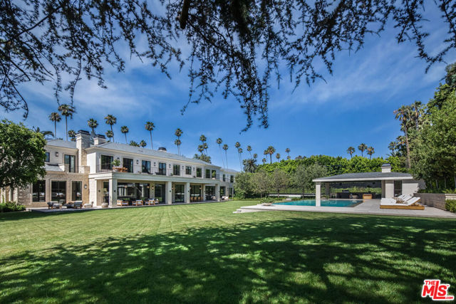 Unsurpassed perfection in the city of Beverly Hills. Nestled behind a grove of 30 year old trees and down a 130-foot long bluestone driveway, this newly finished estate is a masterpiece of architectural design. Impeccably styled, the home spans approximately 17,000sf on one of the largest flat lots north of Sunset. It boasts features such as Riviera Bronze doors/windows, decadent imported stones and woods, and meticulously hand-plastered walls and ceilings. Automated walls of steel and glass seamlessly blend the interiors with a sprawling backyard that's nothing short of breathtaking.  Upon entering through a sleek piano-black lacquered door, we are greeted by a 33-foot high foyer, crowned by an art deco bronze skylight. The main level offers a mocha ash stained library, cinema-grade theater, massive living room showcasing one of the most stunning marble bars you will ever see in a private residence, lavish dining room, five powder rooms, a dream kitchen combined with a breakfast area and family room, dedicated catering kitchen, wine room, a lower-level bedroom suite and an office for security personnel and property management. The upper level indulges with a sprawling 2,000sf primary suite, featuring a separate living room and bedroom, twin spa-inspired bathrooms clad in oversized marble slabs, vast closets, and a 900sf private balcony overlooking the sprawling and extremely private grounds. Also upstairs are four generously sized bedroom suites all with walk-in closets, a family room adorned with bespoke stained cabinetry, and an athlete's dream gym complete with spa bath and massage room. The park like outdoor space rivals the finest resorts with its vast lawns, cabana offering outdoor living and dining, a full-service outdoor kitchen, two powder rooms, an outdoor shower, a zero-edge French blue plastered pool and spa, meandering bluestone pathways, and a fully lighted championship size tennis court. Additional amenities include a Crestron smart home system, six-car garage, elevator, marble clad dog station, advanced security system, and six fireplaces. All just steps away from the Beverly Hills Hotel. Viewings available for pre-qualified clients only.