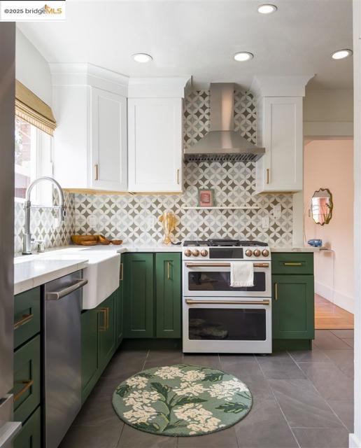 Kitchen featuring green cabinets, white cabinetry, double oven range, and recessed lighting
