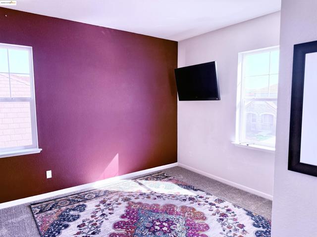 Unfurnished bedroom featuring carpet flooring and baseboards